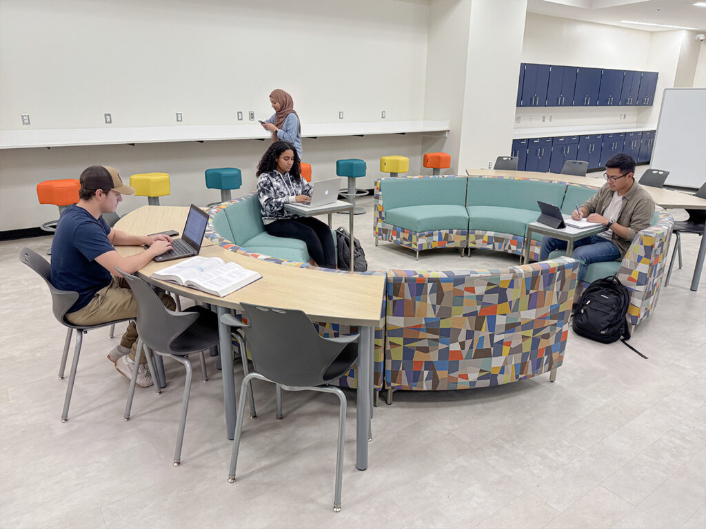 Students collaborating in a modern K-12 media center using modular Chameleon Lounge seating.