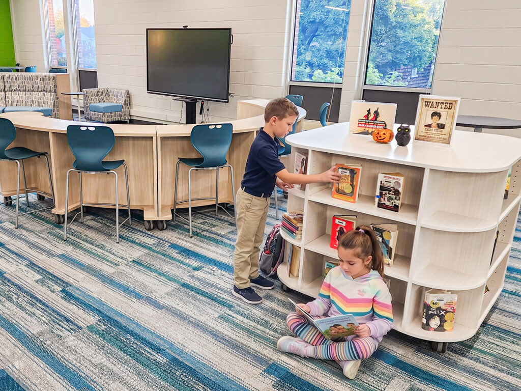 Mobile, low-profile KIO 360 bookcases organizing physical books in a modern learning commons.
